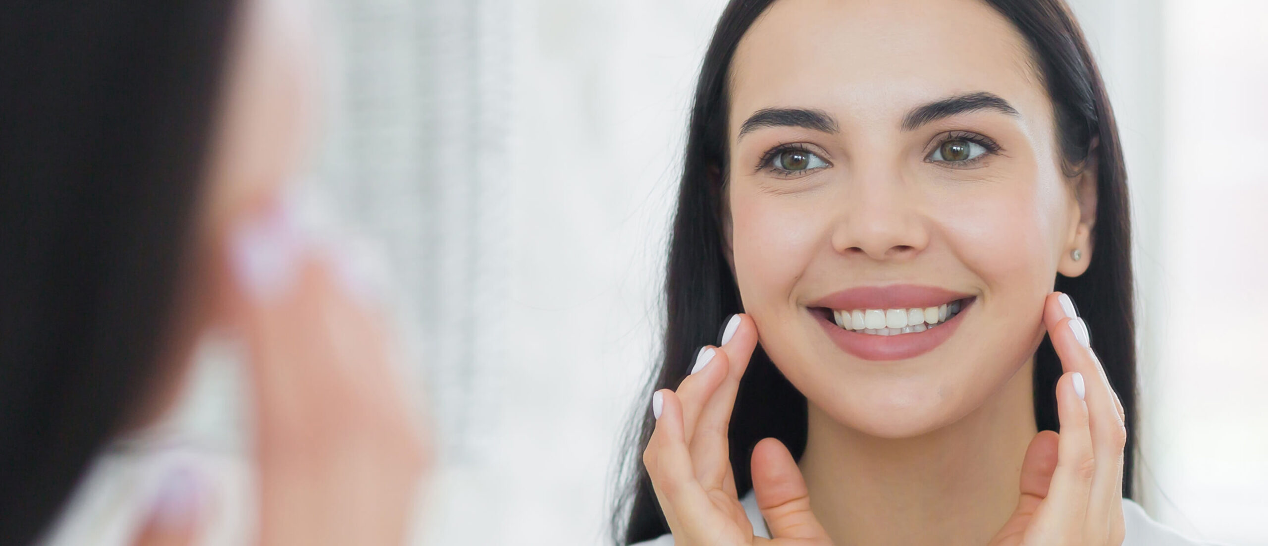 Female looking at herself through a mirror
